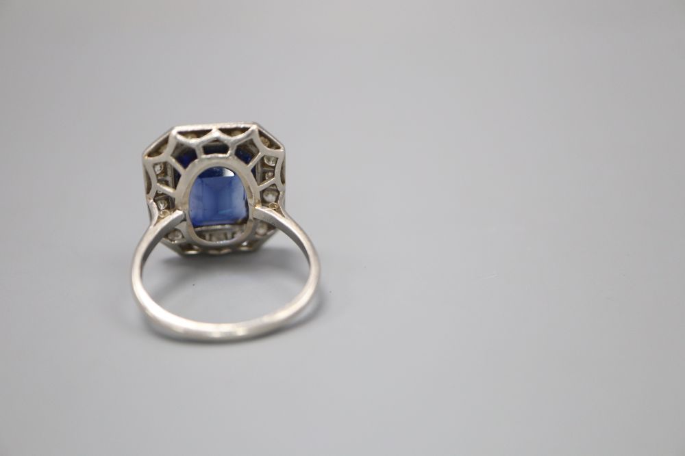 A platinum synthetic sapphire and diamond octagonal cluster ring, size O